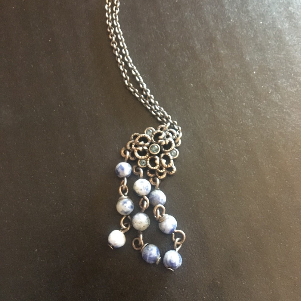 Silver flower necklace with dangling blue stones